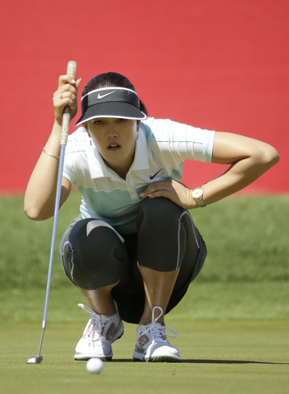 Michelle Wie lines up a putt on the ninth hole during the first round at the Kraft Nabisco Championship golf tournament on Thursday, April 3, 2014, in Rancho Mirage, Calif. (AP Photo/Chris Carlson)