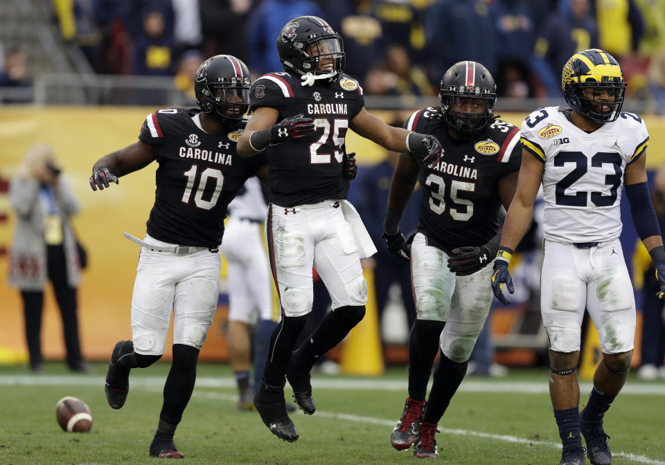 South Carolina’s A.J. Turner (25) celebrates with Skai Moore (10) and Daniel Fennell (35) after recovering a fumble by Michigan during the second half of the Outback Bowl NCAA college football game Monday, Jan. 1, 2018, in Tampa, Fla. South Carolina won the game 26-19. (AP Photo/Chris O’Meara)