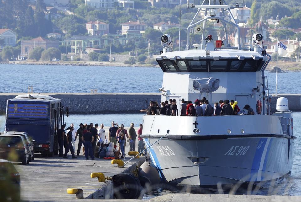 Migrants disembark from a Greek coast vessel after a rescue operation, at the port of Mytilene, on the northeastern Aegean Sea island of Lesbos, Greece, Monday, Aug. 28, 2023. Greek authorities say four people died and 18 were rescued Monday after a boat carrying migrants apparently sank northeast of the Greek island of Lesbos, which lies near the Turkish coast. (AP Photo/Panagiotis Balaskas)