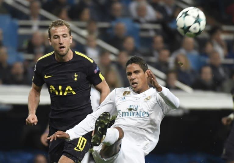 Real Madrid's Raphael Varane (R) fights for the ball with Tottenham Hotspur's Harry Kane during their UEFA Champions League Group H match, at the Santiago Bernabeu stadium in Madrid, on October 17, 2017