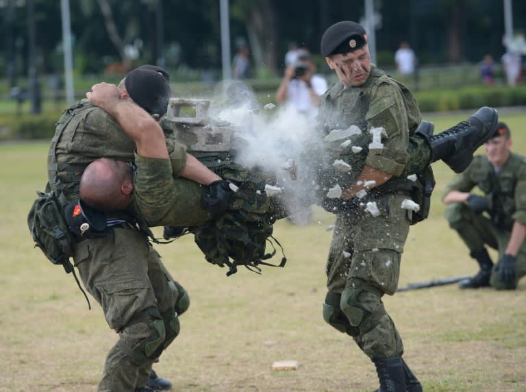 Russian marines attached to the anti-submarine ship Admiral Tributs show their skills during a demonstration at a park in Manila on January 5, 2017