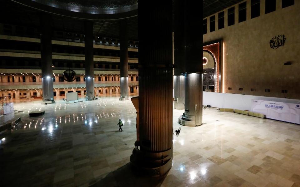 A security officer walks inside The Great Mosque of Istiqlal in Jakarta, Indonesia, as it is closed during the imposition of large-scale restrictions to prevent the spread of coronavirus - REUTERS