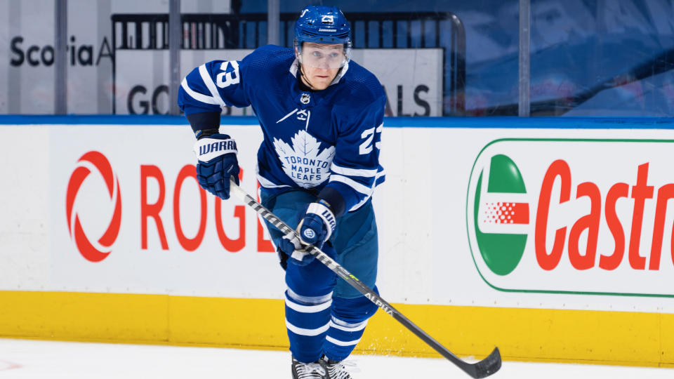 TORONTO, ON - APRIL 29: Travis Dermott #23 of the Toronto Maple Leafs plays the puck against the Vancouver Canucks during the first period at the Scotiabank Arena on April 29, 2021 in Toronto, Ontario, Canada. (Photo by Mark Blinch/NHLI via Getty Images)