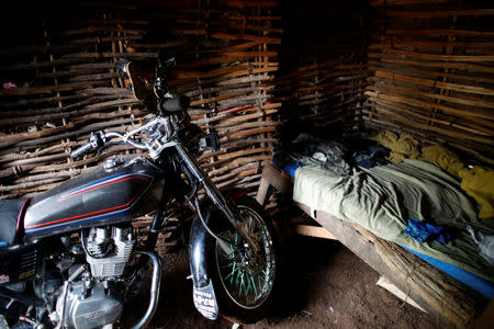 A motorbike is parked beside a bed inside a house in Boucan Ferdinand, Haiti, October 5, 2018. REUTERS/Andres Martinez Casares