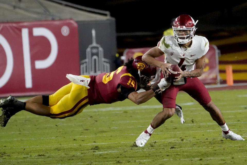 USC safety Talanoa Hufanga pulls down Washington State quarterback Jayden de Laura.