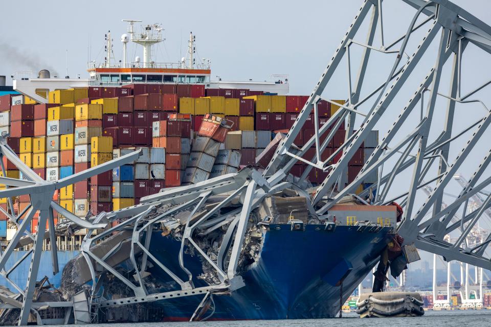 Segments of the collapsed Francis Scott Key Bridge rest on the container ship Dali in Baltimore after the Dali lost power and crashed into one of the bridge's support columns early Tuesday.