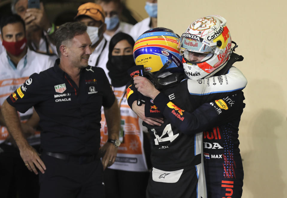 Red Bull driver Max Verstappen of the Netherlands, right, celebrates as Red Bull boss Christian Horner, left, looks on after becoming F1 drivers world champion after winning the Formula One Abu Dhabi Grand Prix in Abu Dhabi, United Arab Emirates, Sunday, Dec. 12. 2021. (AP Photo/Kamran Jebreili, Pool)