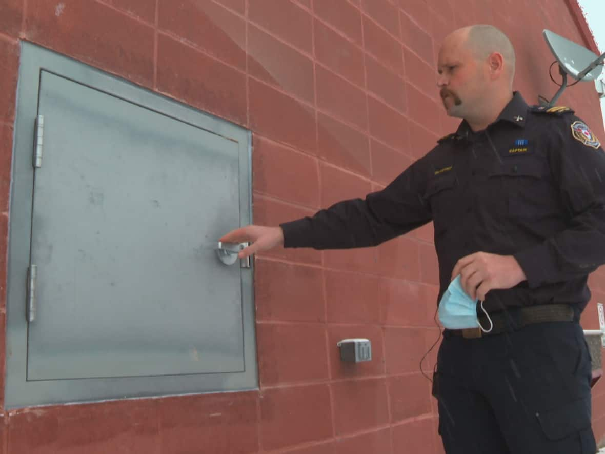 A plain grey metal door outside the fire station in Strathmore will soon be a safe place for parents to surrender their newborns, says Eric Alexander, shift captain of the Strathmore Fire Department. (Terri Trembath/CBC - image credit)