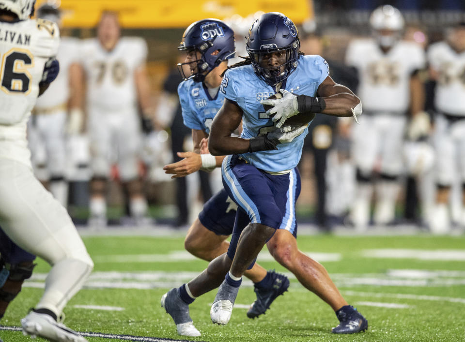 Old Dominion running back Keshawn Wicks, front right, takes a handoff against Appalachian State during the second half of an NCAA college football game Saturday, Oct. 21, 2023, in Norfolk, Va. (AP Photo/Mike Caudill)