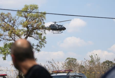 A police helicopter is seen after an armed gang robbed a securities company at the Viracopos airport freight terminal, in Campinas