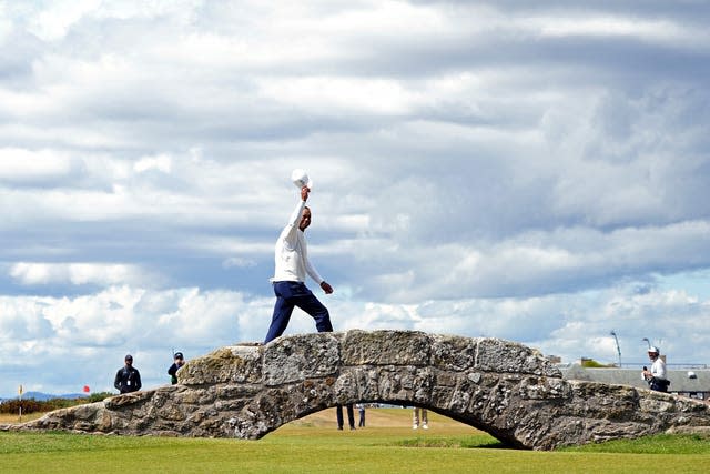 Tiger Woods waves to the crowd as he crosses Swilcan Bridge during day two of The Open at St Andrews. The famously stoic American, who almost had to have his right leg amputated after a car crash last year, was visibly moved by the reception he received as he walked down the 18th fairway of the Old Course – where he has won two of his three Claret Jugs. With the event unlikely to return to at St Andrews for some time, the 15-time major winner bade a likely farewell to the Scottish venue but promised he would be back to play in The Open