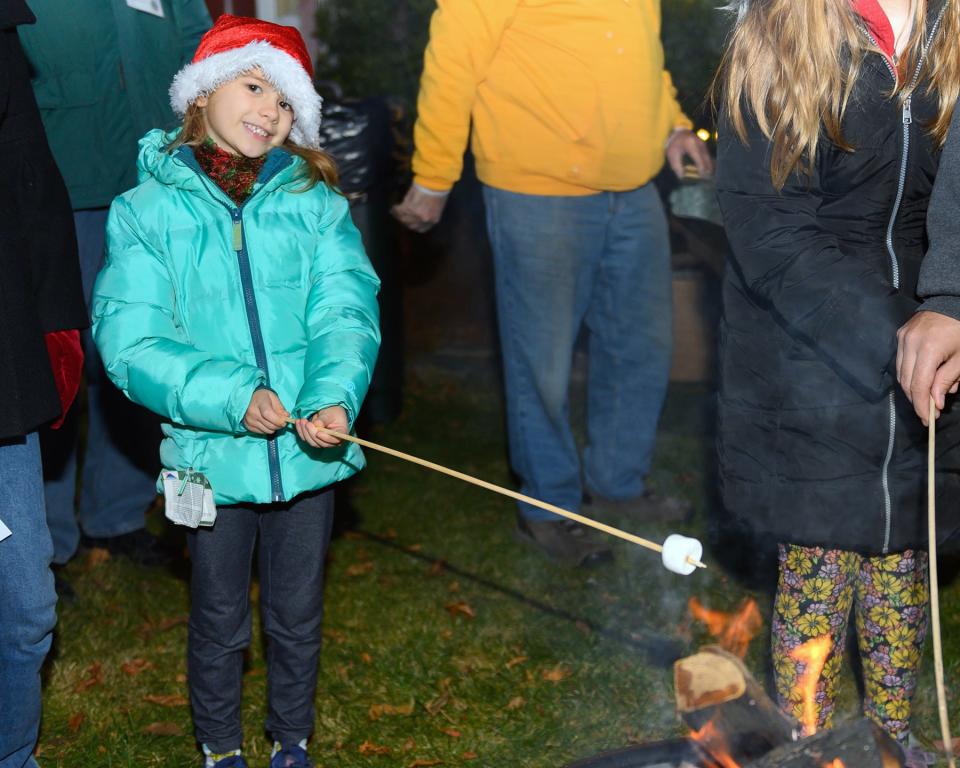 The Lakeville Lions Club held their third annual Christmas tree lighting event on Saturday, Dec. 4 at the club's Main Street headquarters. Seven-year-old Eliana prepares a marshmallow for her s'more.