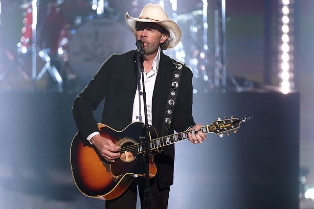 <p>Mickey Bernal/NBC via Getty</p> Toby Keith performing at the People's Choice Country Awards at the Grand Ole Opry in Nashville in September 2023