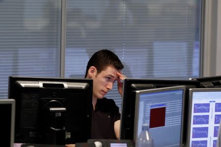 A trader monitors his screen on a trading floor in London January 22, 2010. REUTERS/Stefan Wermuth