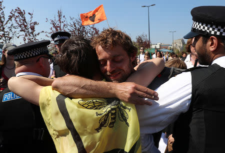 Climate change activists hug each other during the Extinction Rebellion protest on Waterloo Bridge in London, Britain April 20, 2019. REUTERS/Simon Dawson