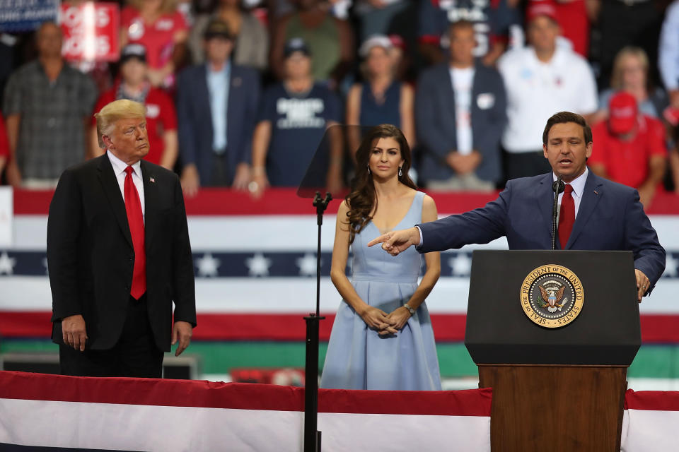President Donald Trump and Casey DeSantis listen to her husband Florida Republican gubernatorial candidate Ron DeSantis speak during a campaign rally at the Hertz Arena on October 31, 2018 in Estero, Florida. (Joe Raedle/Getty Images)