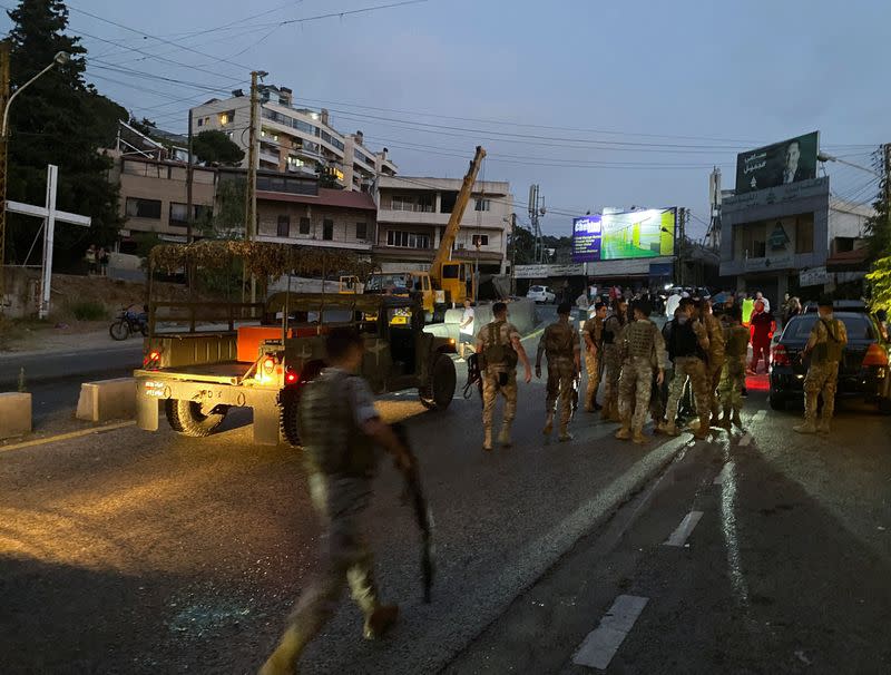 Lebanese army members gather near the area where a lorry was overturned in the town of Kahaleh