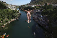 A diver jumps from the Old Bridge during the 456th traditional annual high diving competition in Mostar, Bosnia, Sunday, July 31, 2022. A total of 31 divers from Bosnia and region leapt from the 23-meter-high bridge into the Neretva River. (AP Photo/Armin Durgut)