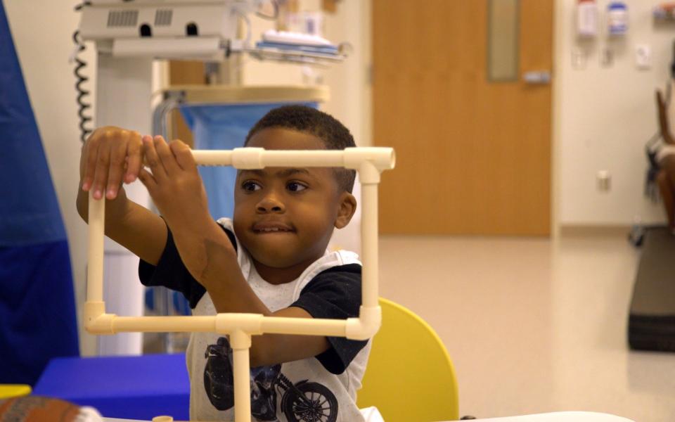 Zion Harvey underwent a double hand transplant. When he was followed up 18 months after the procedure, he was also able to write and also feed and dress himself independently - Credit:  Children’s Hospital of Philadelphia