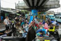 Jakarta residents hit by flooding took shelter from heavy rain under flyovers