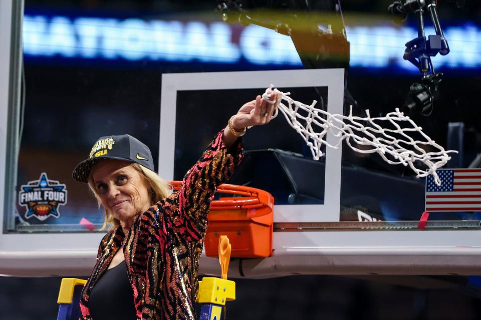 LSU women's basketball coach Kim Mulkey cuts down a piece of the net after the Tigers beat Iowa in Sunday's NCAA championship game. It was Mulkey's fourth national title that she has now won at two different schools. It took her two seasons to transform LSU into a championship program.