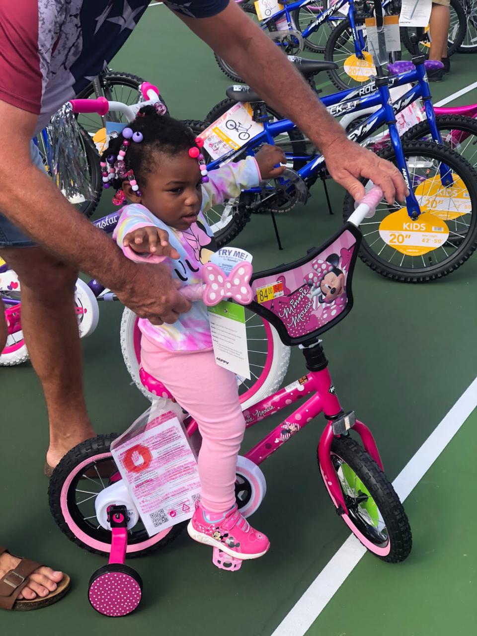 A little girl got a bike just her size, complete with training wheels, at last year's annual bike giveaway in Daytona Beach.