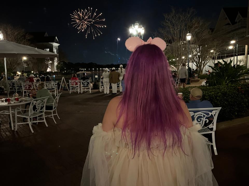 jenna watching the fireworks coming from magic kingdom from outside the grand floridian  resort