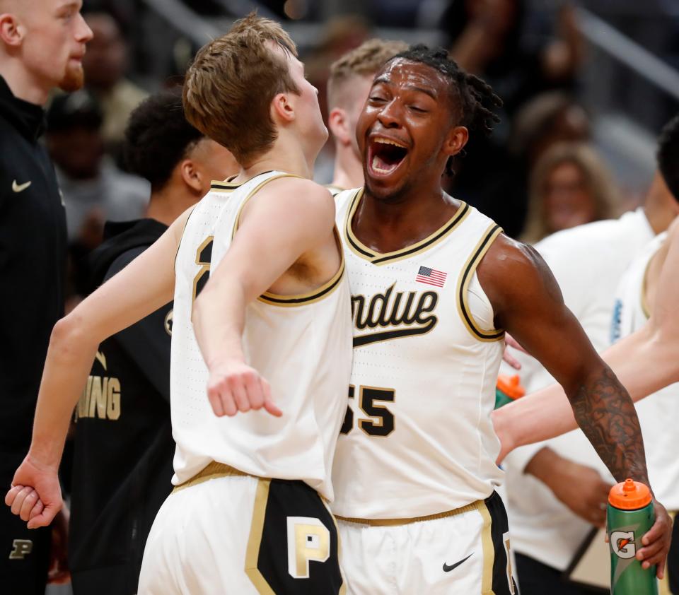 Purdue Boilermakers guard Fletcher Loyer (2) and Purdue Boilermakers guard Lance Jones (55) celebrate during a timeout during the NCAA menâ€™s basketball game against the Arizona Wildcats, Saturday, Dec. 16, 2023, at Gainbridge Fieldhouse in Indianapolis. Purdue Boilermakers won 92-84.