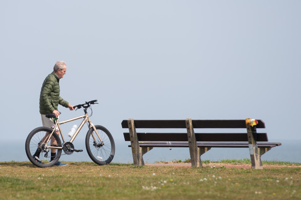 A man takes a break during his daily exercise at Gorleston-on-Sea in Norfolk as the UK continues in lockdown to help curb the spread of the coronavirus.