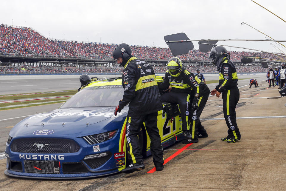 Paul Menard (21) climbs out of his car as Matt Crafton prepares to relieve him during a NASCAR Cup Series auto race at Talladega Superspeedway in Talladega, Ala., Sunday, Oct. 13, 2019. (AP Photo/Butch Dill)