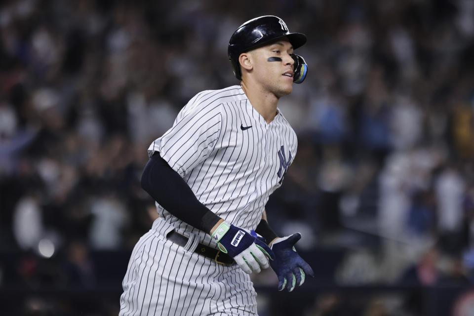 New York Yankees' Aaron Judge runs toward first after hitting his 60th home run of the season, during the ninth inning of the team's baseball game against the Pittsburgh Pirates on Tuesday, Sept. 20, 2022, in New York. (AP Photo/Jessie Alcheh)