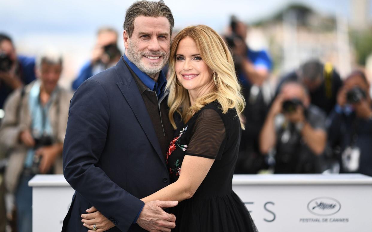 John Travolta and his wife Kelly, who has passed away from breast cancer  - ANNE-CHRISTINE POUJOULAT/ AFP