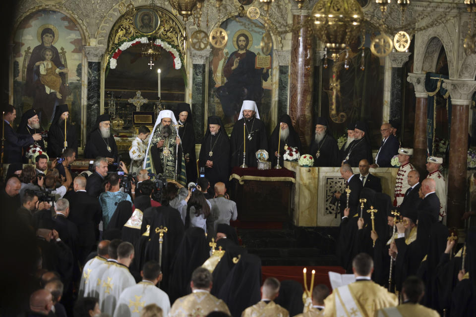 The newly elected Bulgarian Patriarch Daniil holds a cross after his enthronement ceremony at Alexander Nevsky Cathedral in Sofia, Bulgaria, Sunday, June 30, 2024. Bulgaria's Orthodox Church on Sunday elected Daniil, a 52-year-old metropolitan considered to be pro-Russian, as its new leader in a disputed vote that reflects the divisions in the church and in the society. (AP Photo/Valentina Petrova)