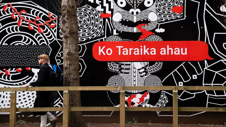 People walk past Maori language signs in Wellington, New Zealand, in 2018.  - Marty Melville/AFP/Getty Images