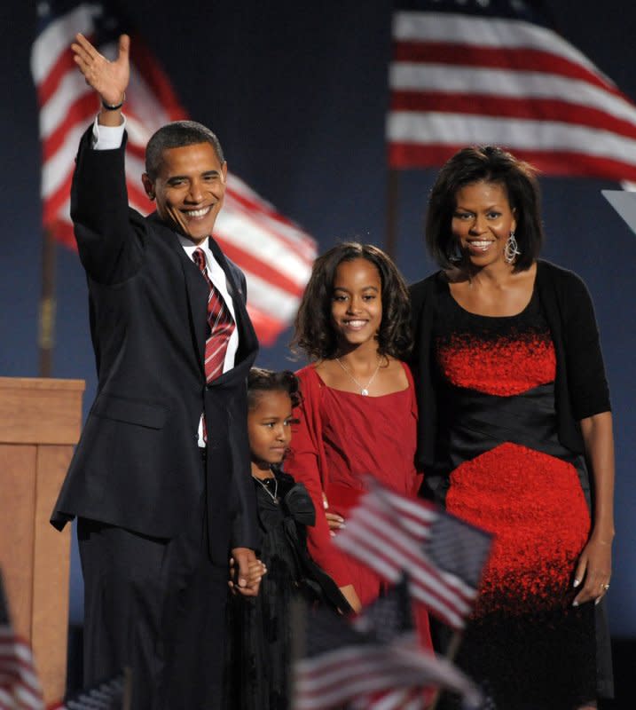 President-elect Barack Obama walks on stage with his daughters Sasha and Malia and his wife Michelle (L to R) in Grant Park in Chicago during an election night celebration on November 4, 2008. File Photo by Roger L. Wollenberg/UPI