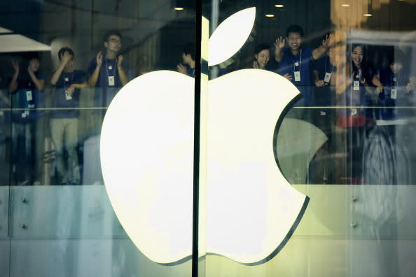 Chinese Apple staff members cheer in the new Apple Store before it opens in Wangfujing shopping district. (Photo by Feng Li/Getty Images)