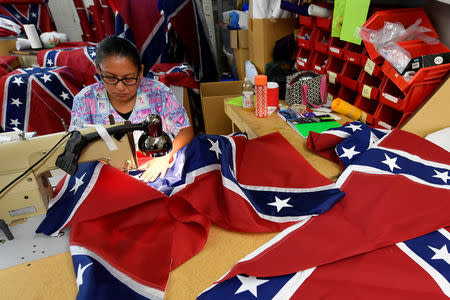 Blanca Hernandez sews stars on a Confederate Battle Flag in the Alabama Flag & Banner shop in Huntsville, Alabama, U.S., August 24, 2017. REUTERS/Harrison McClary