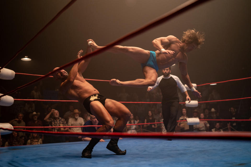 One man jump kicking another in a scene from "The Iron Claw"
