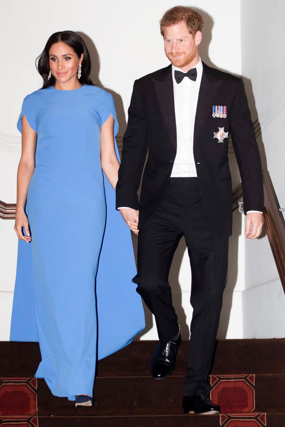 <p><strong>October 2018 </strong>The Duke and Duchess of Sussex dressed up for a state dinner in Fiji, with Meghan wearing a blue Safiyaa gown. </p>