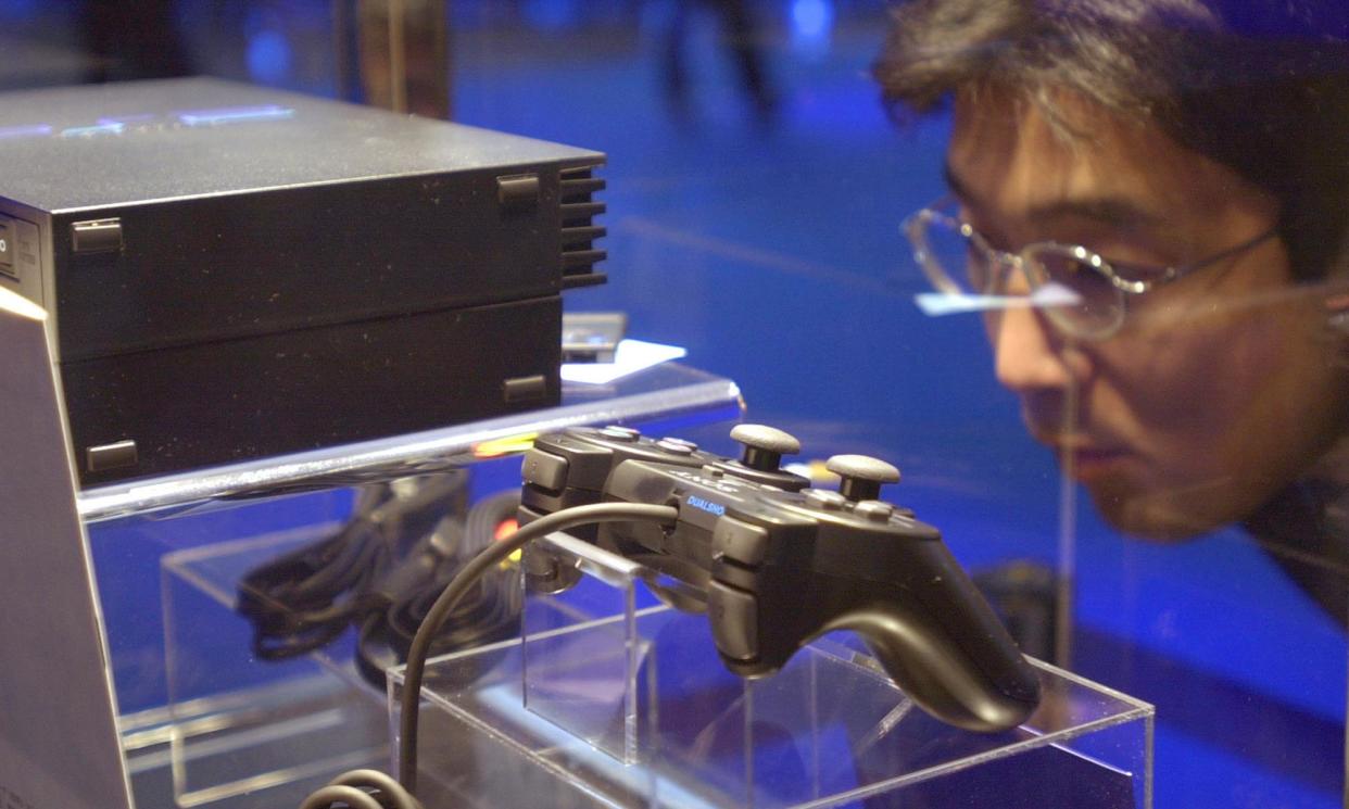 <span>Consoling himself ... A customer considers one of 160m PS2s sold since the console’s release in 2000.</span><span>Photograph: Katsumi Kasahara/AP</span>