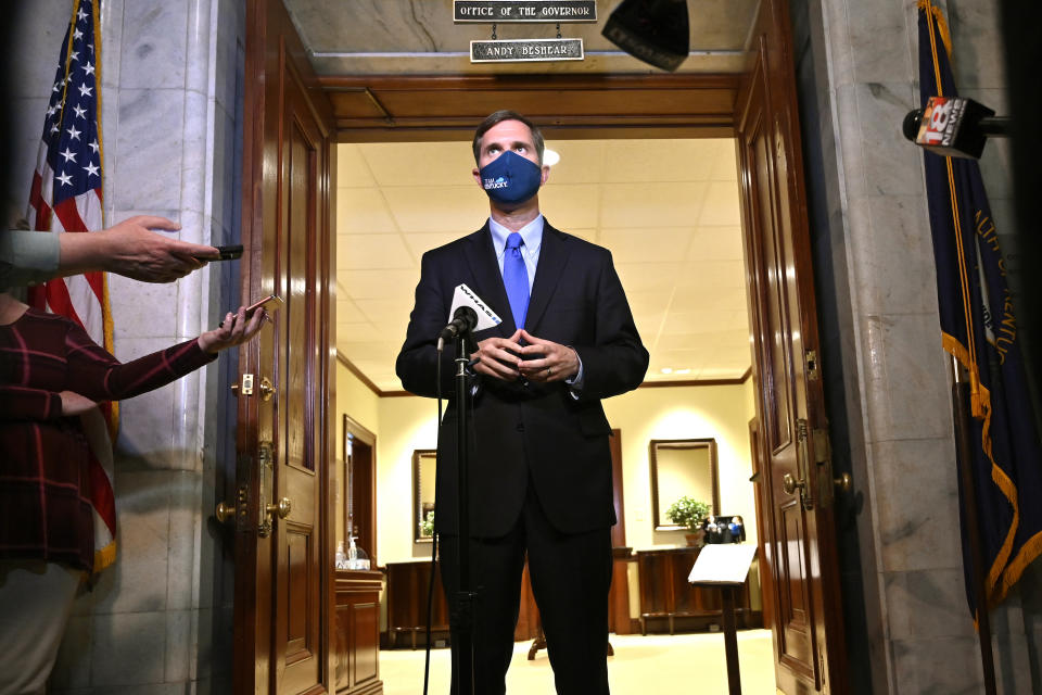 Kentucky Gov. Andy Beshear speaks to reporters following the signing of bills related to the American Rescue Plan Act at the Kentucky State Capitol in Frankfort, Ky., Wednesday, April 7, 2021. (AP Photo/Timothy D. Easley)