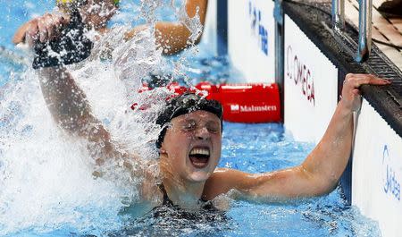 Katie Ledecky of the U.S. celebrates after setting a new world record and winning the women's 800m freestyle final at the Aquatics World Championships in Kazan, Russia, August 8, 2015. REUTERS/Michael Dalder