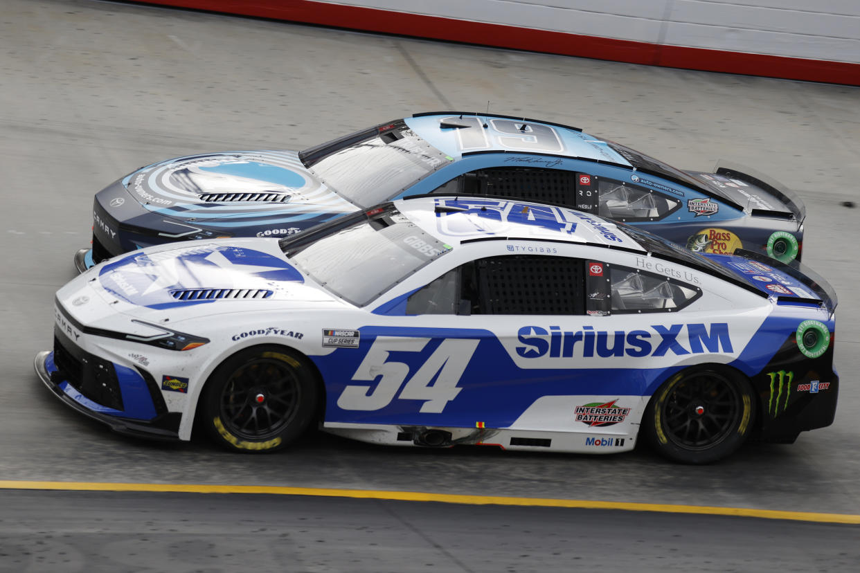 BRISTOL, TN - MARCH 17: Ty Gibbs (#54 Joe Gibbs Racing Sirius XM Toyota) races with Martin Truex Jr (#19 Joe Gibbs Racing Auto-Owners Insurance Toyota) in turn 3 during the running of the NASCAR Cup Series Food City 500 on March 17, 2024 at Bristol Motor Speedway in Bristol, TN. (Photo by Jeff Robinson/Icon Sportswire via Getty Images)