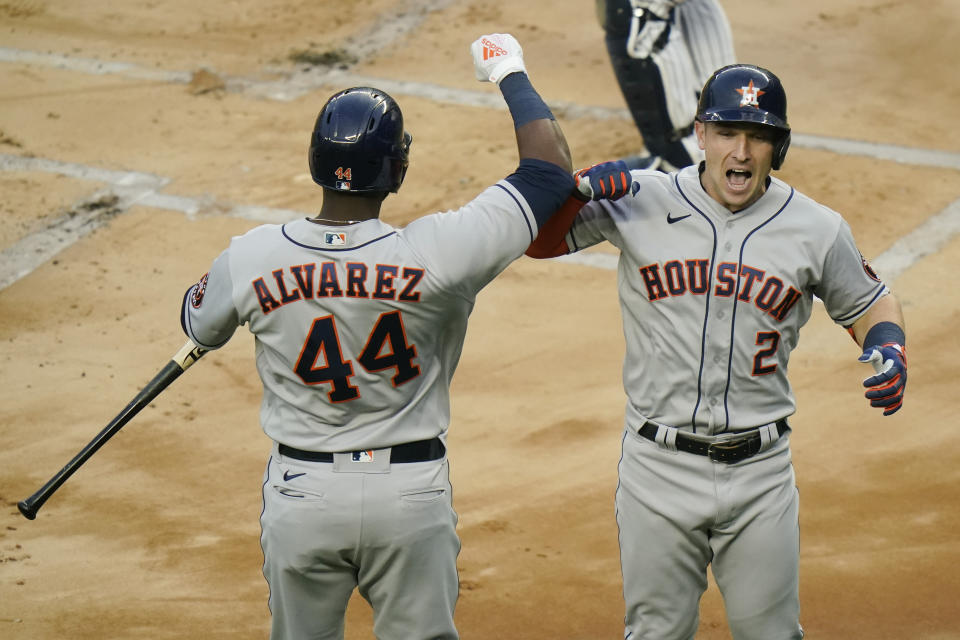 Houston Astros' Alex Bregman, right, celebrates with Yordan Alvarez, left, after hitting a home run during the first inning of a baseball game against the New York Yankees Tuesday, May 4, 2021, in New York. (AP Photo/Frank Franklin II)