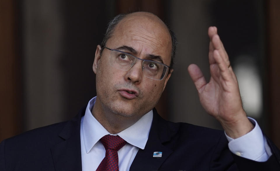 Wilson Witzel gives a statement after a court temporarily removed the former federal judge from his office of Rio de Janeiro state Governor due to corruption charges, at the Palacio de Laranjeiras governors residence in Rio de Janeiro, Brazil, Friday, Aug. 28, 2020. Investigators accuse Witzel of participating in a scheme involving fraud in public contracts to benefit companies linked to him and others under investigation. (AP Photo/Silvia Izquierdo)