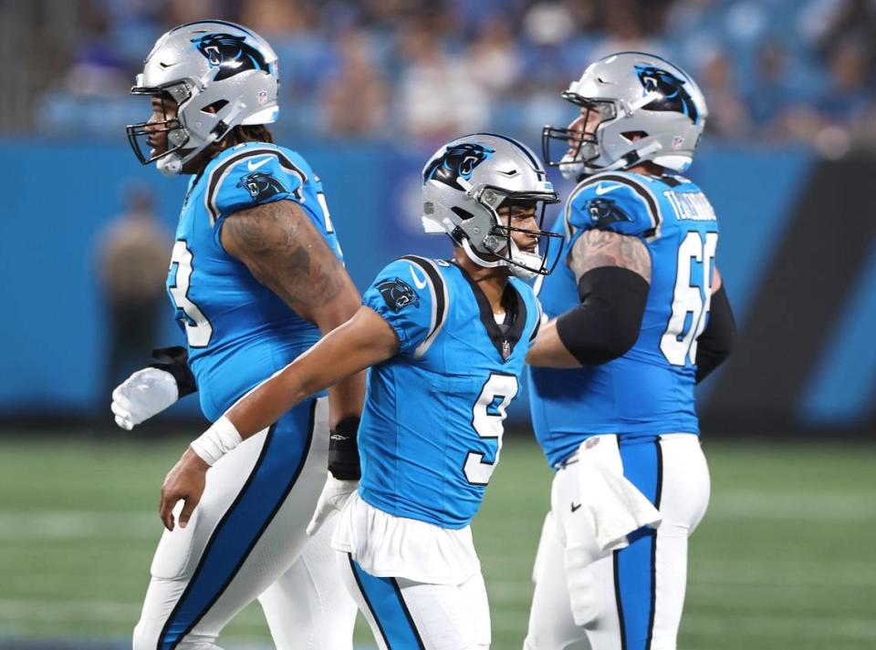 Carolina Panthers quarterback Bryce Young, center, slaps hands with his teammates following a series against the Detroit Lions during first half action on Friday, August 25, 2023 at Bank of America Stadium in Charlotte, NC.