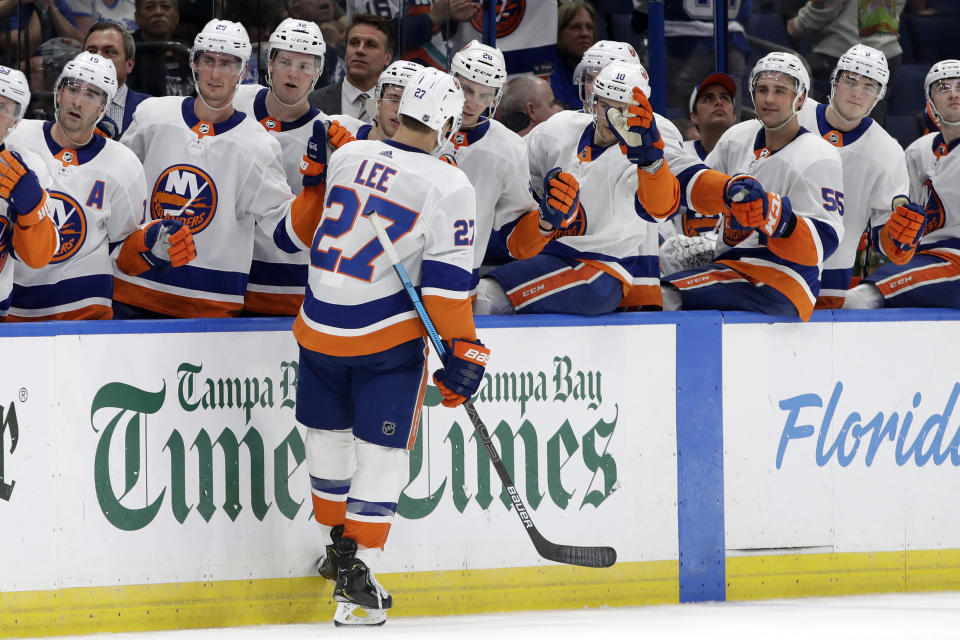 New York Islanders left wing Anders Lee (27) celebrates with the bench after scoring against the Tampa Bay Lightning during the third period of an NHL hockey game Monday, Dec. 9, 2019, in Tampa, Fla. (AP Photo/Chris O'Meara)