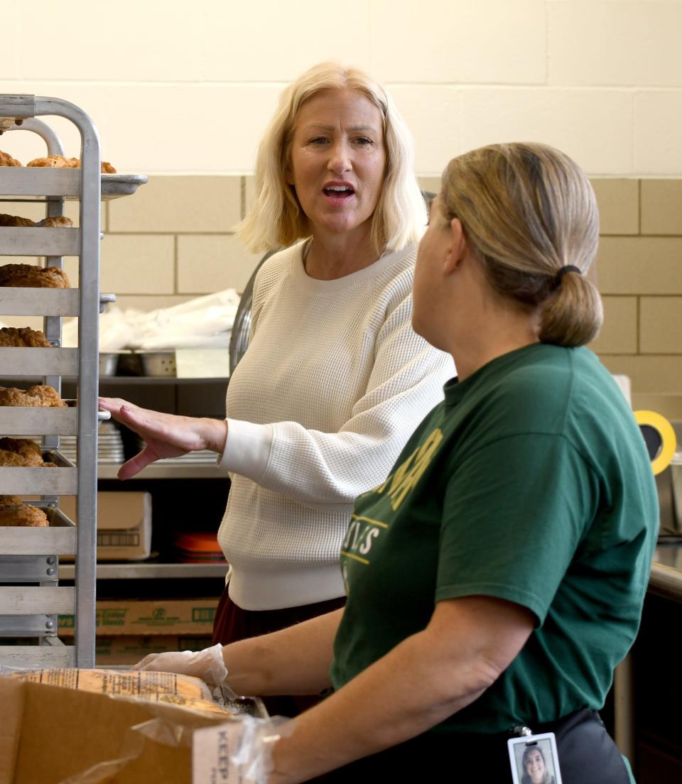 Jennifer Rex, Plain Local's child nutrition director, speaks with cafeteria worker Amy Kozma during food prep in the cafeteria at Barr Elementary School on Thursday.