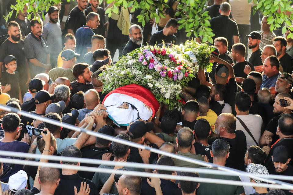 Members of the Palestinian Fatah Movement carry the body of Abu Ashraf al-Armoushi, the Palestinian National Security Commander in the Saida region, during his funeral procession at Rashidiyeh Palestinian refugee camp, southern Lebanon, Monday, July 31, 2023. (AP Photo/Mohammad Zaatari)