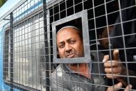 A protester reacts from a police van after being arrested at the Town Hall during a demonstration held against India's new citizenship law in spite of a curfew in Bangalore on December 19, 2019. - Indians defied bans on assembly on December 19 in cities nationwide as anger swells against a citizenship law seen as discriminatory against Muslims, following days of protests, clashes and riots that have left six dead. (Photo by Manjunath Kiran / AFP) (Photo by MANJUNATH KIRAN/AFP via Getty Images)